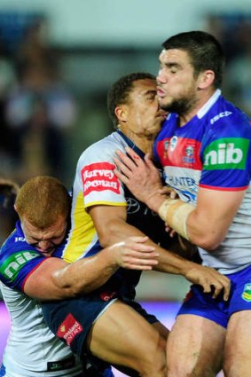 Charged: Kade Snowden's shoulder makes contact with the jaw of North Queensland's Ray Thompson.