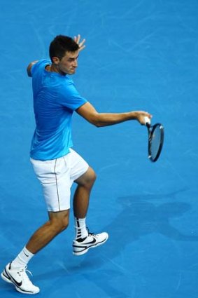 Bernard Tomic returns a forehand volley during his singles match against Tommy Haas.