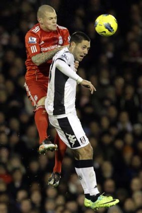 In full flight ... Fulham goalscorer Clint Dempsey, right, competes for the ball with Liverpool's Martin Skrtel at Craven Cottage.