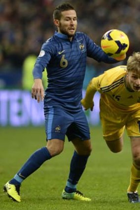 France's defender Yohan Cabaye (L) vies with Ukraine's midfielder Roman Bezus.