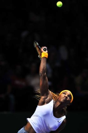 Power: Serena Williams serves to Petra Kvitova in their WTA Championships match.