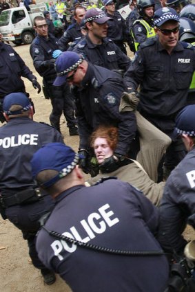 Police forcibly remove a protester.