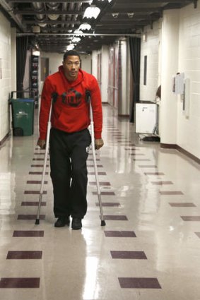 Chicago Bulls guard Derrick Rose walks down the hall on crutches to a news conference about his injured knee at the United Center on Thursday in Chicago.