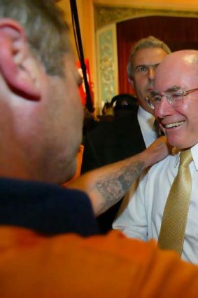 Former prime minister John Howard is congratulated by a blue collar timber worker during the 2004 election campaign.