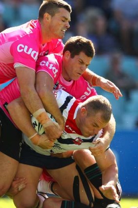Tag team effort &#8230; the Roosters' Martin Kennedy is held by three Panthers yesterday.