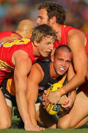 Cornered: Richmond's Jake King is locked up during Saturday's clash with the Gold Coast in Cairns.