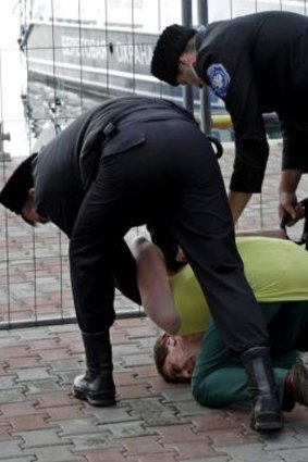 Cossacks restrain a male member of Pussy Riot after the group tried to perform in Sochi.