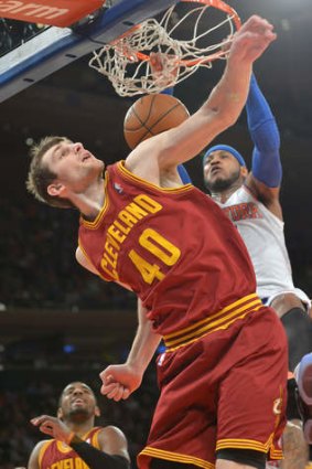 New York Knicks forward Carmelo Anthony dunks the ball over Cleveland Cavaliers centre Tyler Zeller at Madison Square Garden.
