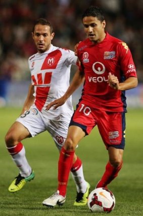 Marcelo Carrusca of Adelaide gets away from Massimo Murdocca of Melbourne Heart. 