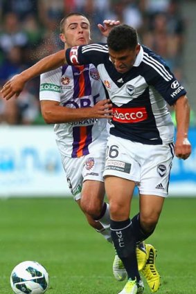 Sweat and tears: Victory's Andrew Nabbout and Perth's Joshua Risdon contest the ball during the round nine A-League match on Friday.
