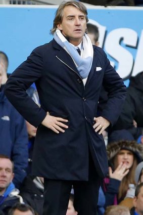 Manchester City manager Roberto Mancini watches the game against Everton.