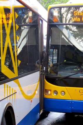 Two buses sit on Adelaide Street after colliding.