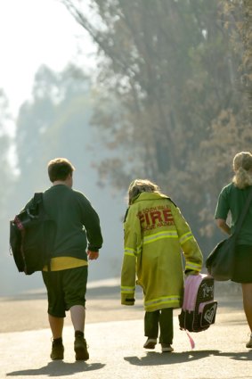 Flowerdale Primary School students go to class yesterday on their first day back since the fires.