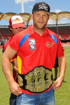 Gary Ablett sports an UFC title belt during a media session on Wednesday.