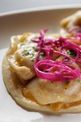 Vareniki with cauliflower puree, onion butter and pickled red cabbage dish.