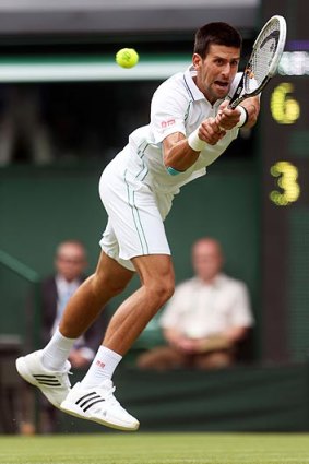 Novak Djokovic of Serbia fires a backhand in his first-round match against Juan Carlos Ferrero of Spain.