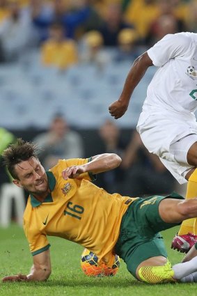 Socceroos James Holland and Alex Wilkinson block a shot by South Africa's Tokelo Anthony Rantie at ANZ Stadium on Monday.