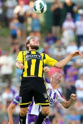 On a string: Jeremy Brockie controls the ball under pressure from a Perth defender.