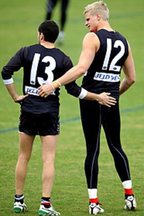 Marching on: Leigh Montagna (No. 13) gets support from a recovering Nick Riewoldt at training yesterday.