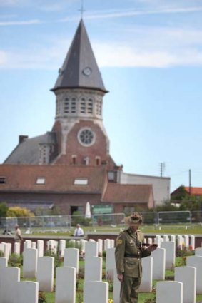 Poignant place &#8230; an Australian soldier pauses to reflect in the Fromelles cemetery.