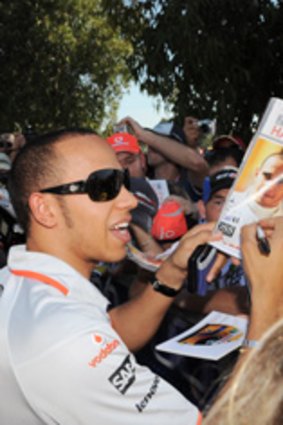 Lewis Hamilton signs autographs for fans at Albert Park.