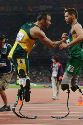 Alan Fonteles Cardoso Oliveira is congratulated by Oscar Pistorius after winning gold in the Men's 200m - T44 Final.