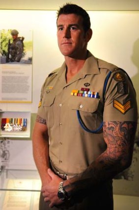 Australian Victoria Cross recipient, Corporal Ben Roberts-Smith VC, MG with his  medal display at the Australian War Memorial.