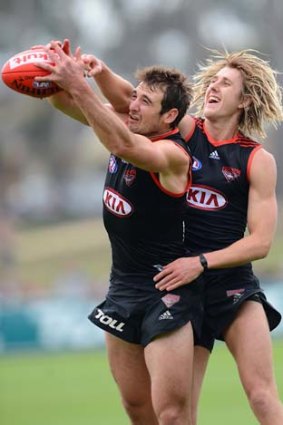 Nice try: Essendon captain Jobe Watson gets the better of Dyson Heppell at training on Wednesday.