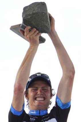 Johan van Summeren of Belgium holds the cobblestone trophy aloft.