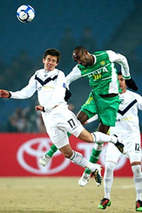 Melbourne's Matthew Foschini (left) and Valdo of Beijing Guoan fly high in their Asian Champions League clash.