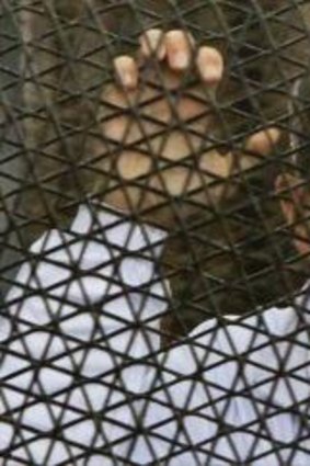 Australian journalist Peter Greste inside the defendants' cage during the trial. He was sentenced to seven years in jail on Monday.