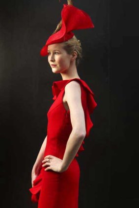 Alex Foxcroft, 23, trainee solicitor, wore a ruffle trimmed wool crepe de chine sheath by young designer brand Variations on a Theme, with chic matched sinamay and straw swirl headpiece with pheasant feather by The Essential Hat. Woven straw print pumps by Dolce and Gabbana.