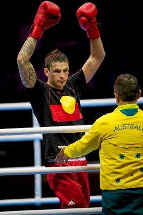 Australian light heavyweight boxer Damien Hooper walks into the ring for his first round bout wearing an Aboriginal flag t-shirt.