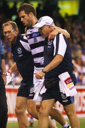 Jared Rivers of the Cats is helped from the field in round five.