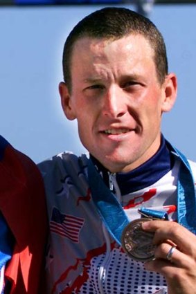 Lance Armstrong holds the bronze medal for the Olympic individual time trial he won in Sydney, in this September 30, 2000 filephoto.