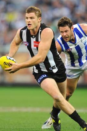 Collingwood's Heath Shaw is pursued by North's Sam Gibson at the MCG.