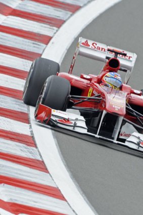 At full throttle: Ferrari's Fernando Alonso heads into a turn during practice for the German Grand Prix.