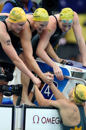 The Australian women's 4x100 medley relay team (including Jones, top centre) winning gold in Beijing, beating their US rivals in world-record time.