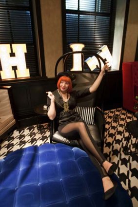 The red-wigged "Directors of Chaos" at Sydney's new QT hotel are kitted out in black bondage-inspired outfits.