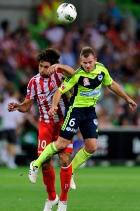 Leigh Broxham (right) clashes with Melbourne Heart's Wayne Srhoj.