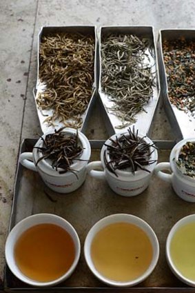 Sri Lanka's exotic Golden Tips (L) and Silver Tips (C) and a Japanese Sencha (R) tea brewed on display at a factory in Kandana on the outskirts of Colombo.