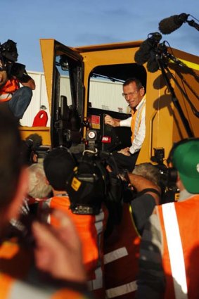 Tony Abbott sits in a mining vehicle during a visit to Barminco mining company in Perth.