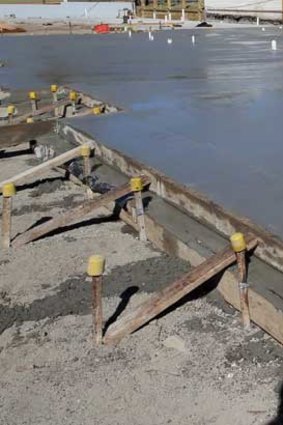 Builders prepare a slab.