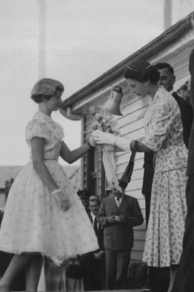 The Queen accepting a posy from 14-year-old Anne Young in 1954.