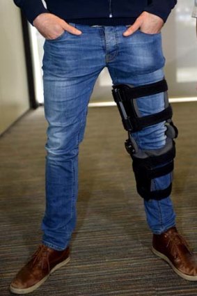 Chris Judd with his injured knee in a brace.