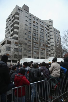 A long line of asylum applicants wait outside the the Central Registration Office for Asylum Seekers in Berlin on Wednesday.