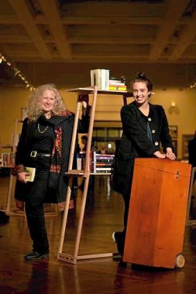 Author Kirsty Murray (left) with designer Georgia Hutchison and the mobile book cases from a writers' tour of India.