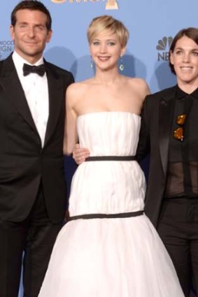 Ellison, right, with <i>American Hustle</i> stars Bradley Cooper and Jennifer Lawrence.