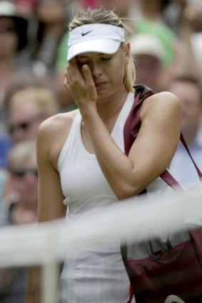 A downcast Sharapova leaves the court after her defeat.