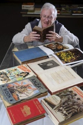 KEEN EYE: Cedric Bear peruses a pile of rare books destined for the fair.